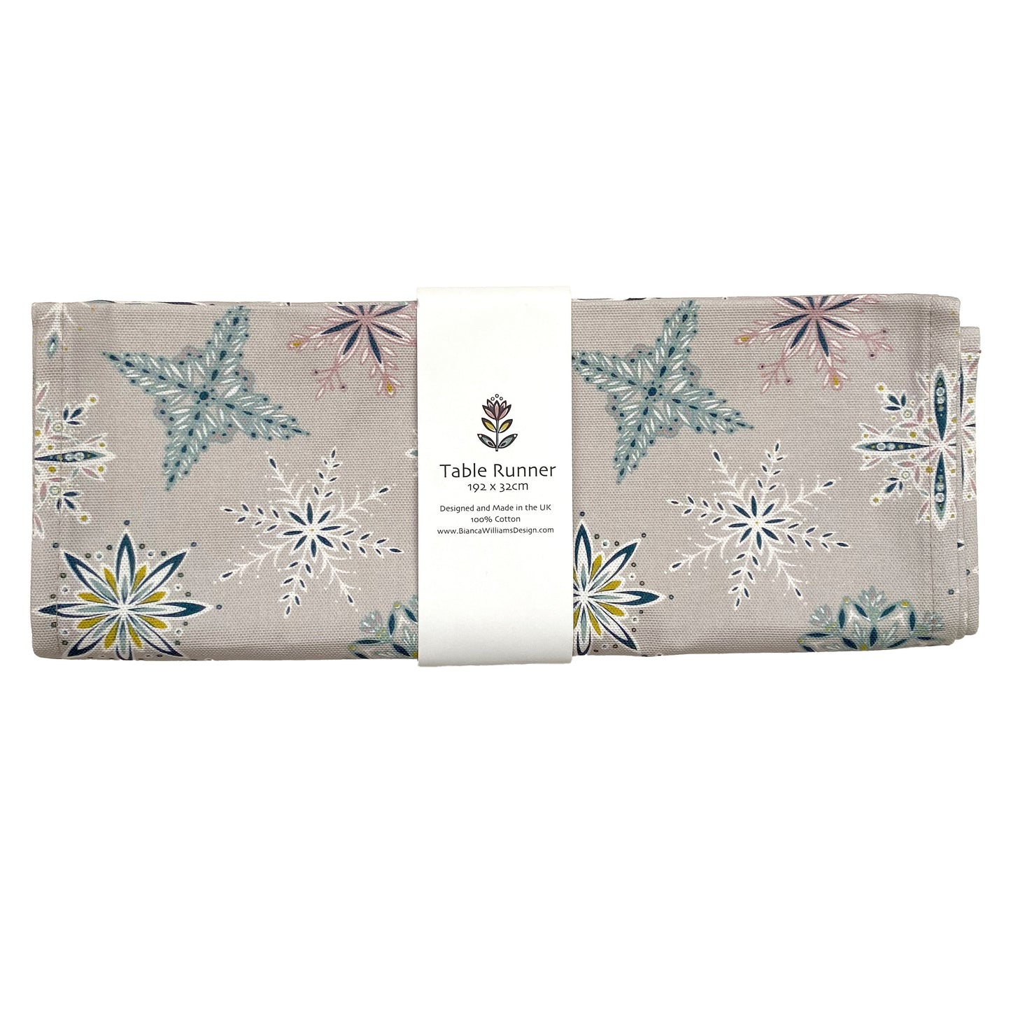 A Silver grey Snowflake table runner has been packaged in a branded belly band and placed on a white background.