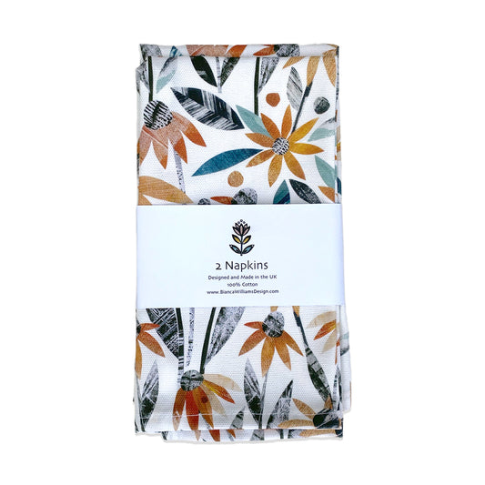 A pair of Rudbeckia Napkins packaged in Branded Belly bands on a white background.