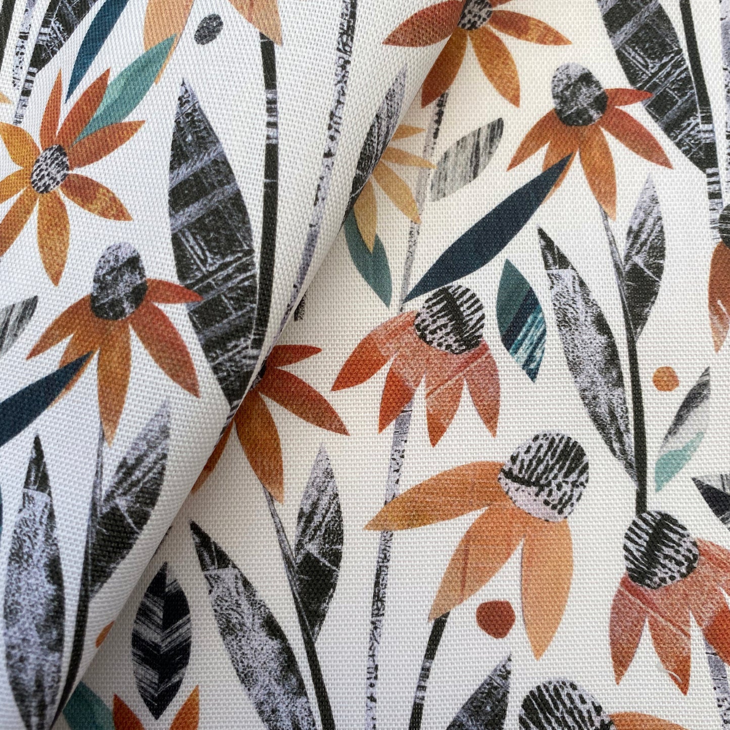 Close up of the textured Orange Coneflowers with green and grey leaves printed onto a white cotton background.