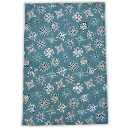 An opened out Blue snowflake tea towel on a white background.