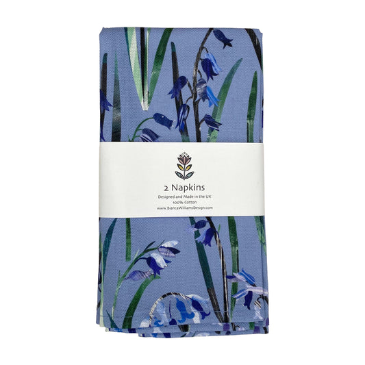 A pair of Bluebell Napkins packaged in a branded belly band and placed on a white background.