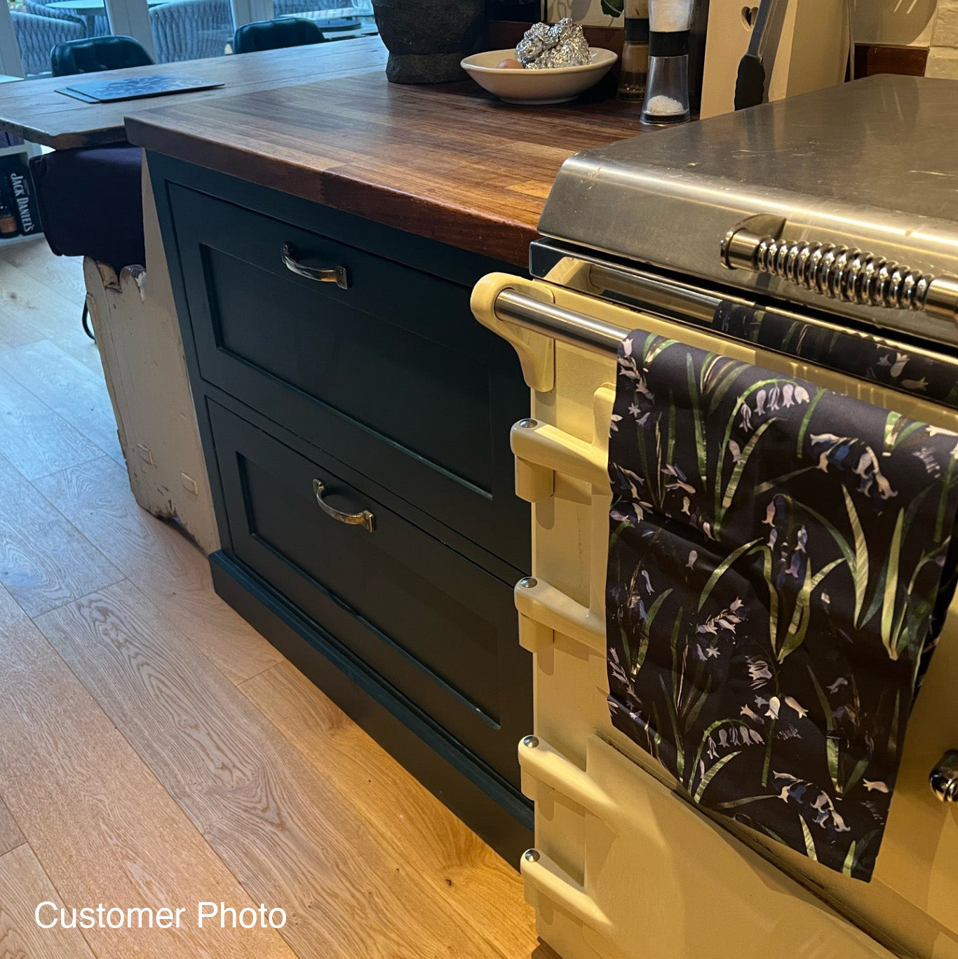 A Navy Blue Bluebell Tea Towel hung over the rail on a Rayburn cooker.
