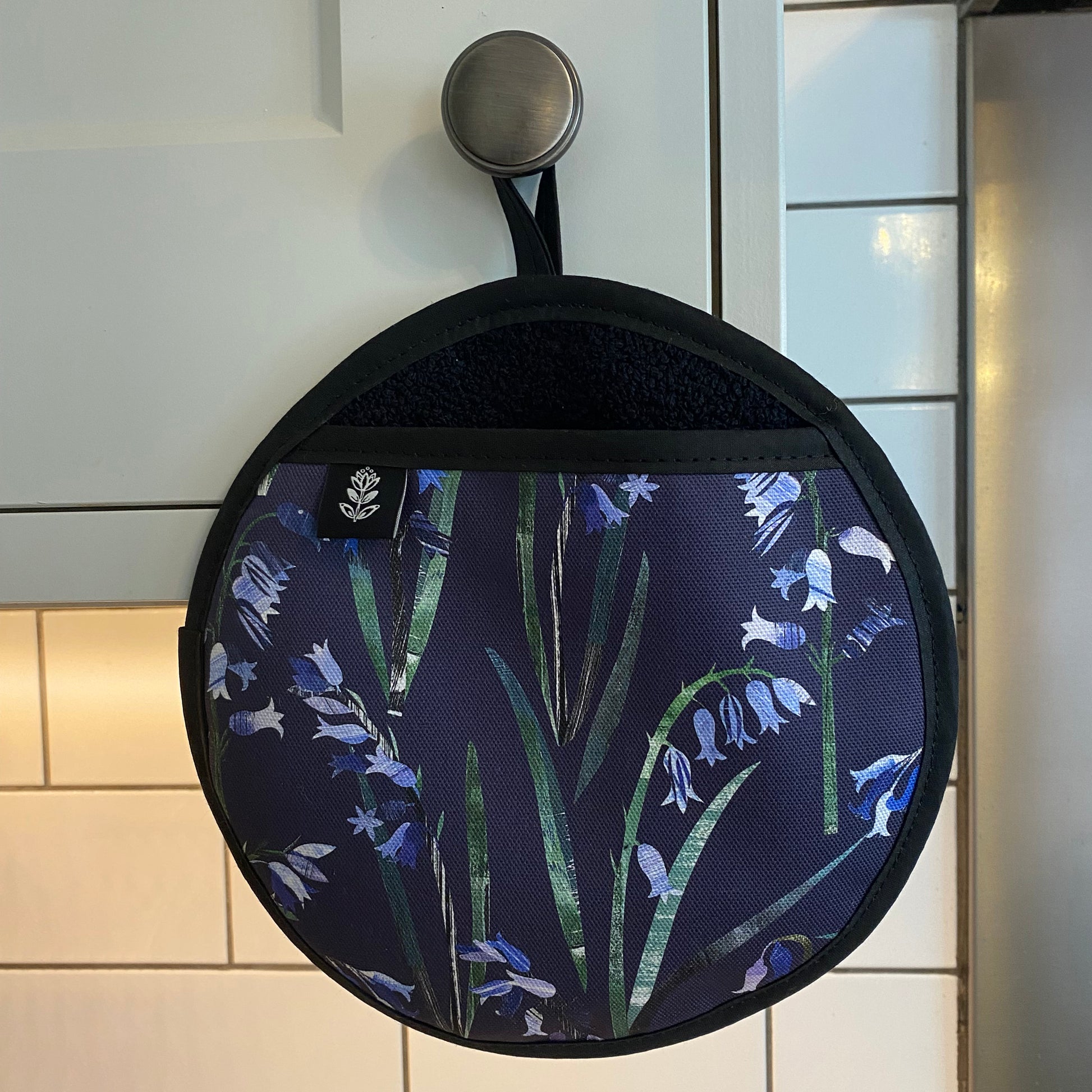 The Bluebell pot grab has been hung up on a kitchen cupboard door handle.