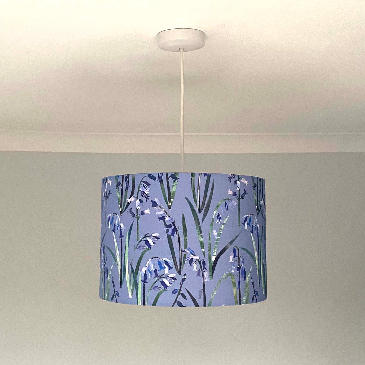 Bluebell lampshade, shown here in a Medium Size and as a Ceiling Pendant.  The design features Blue Bluebell flowers with green leaves on a light blue background.