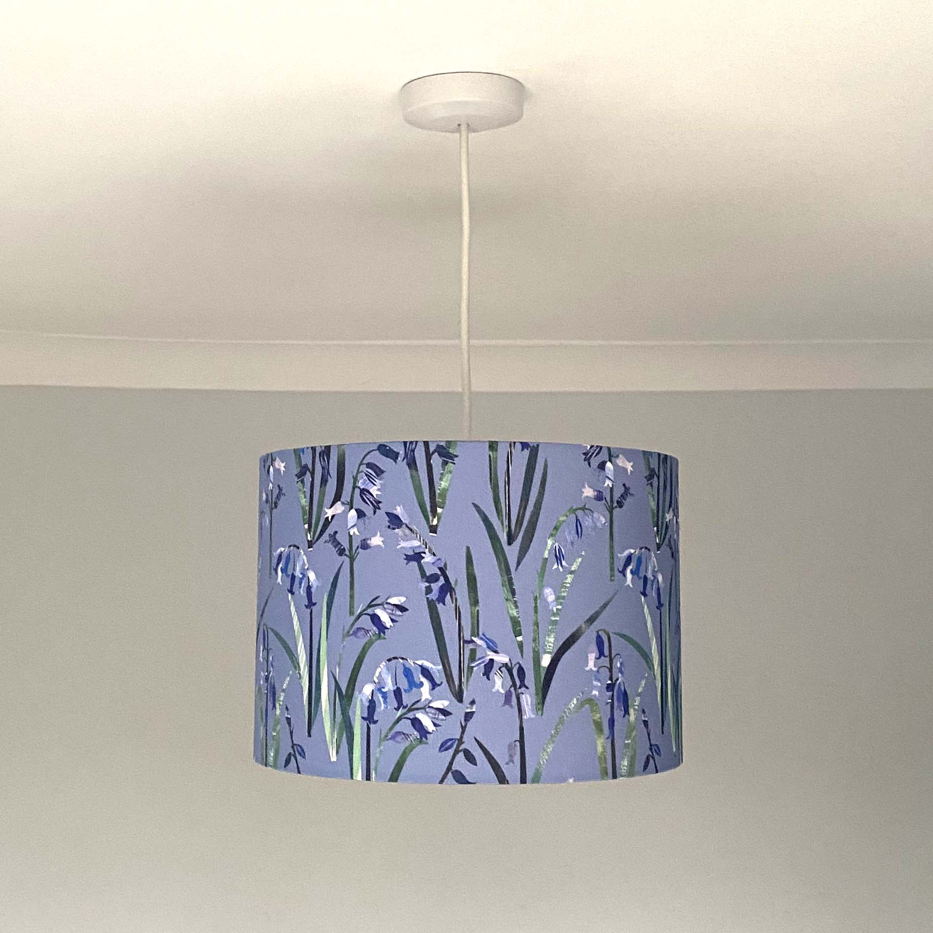 Bluebell lampshade, shown here in a Medium Size and as a Ceiling Pendant.  The design features Blue Bluebell flowers with green leaves on a light blue background.