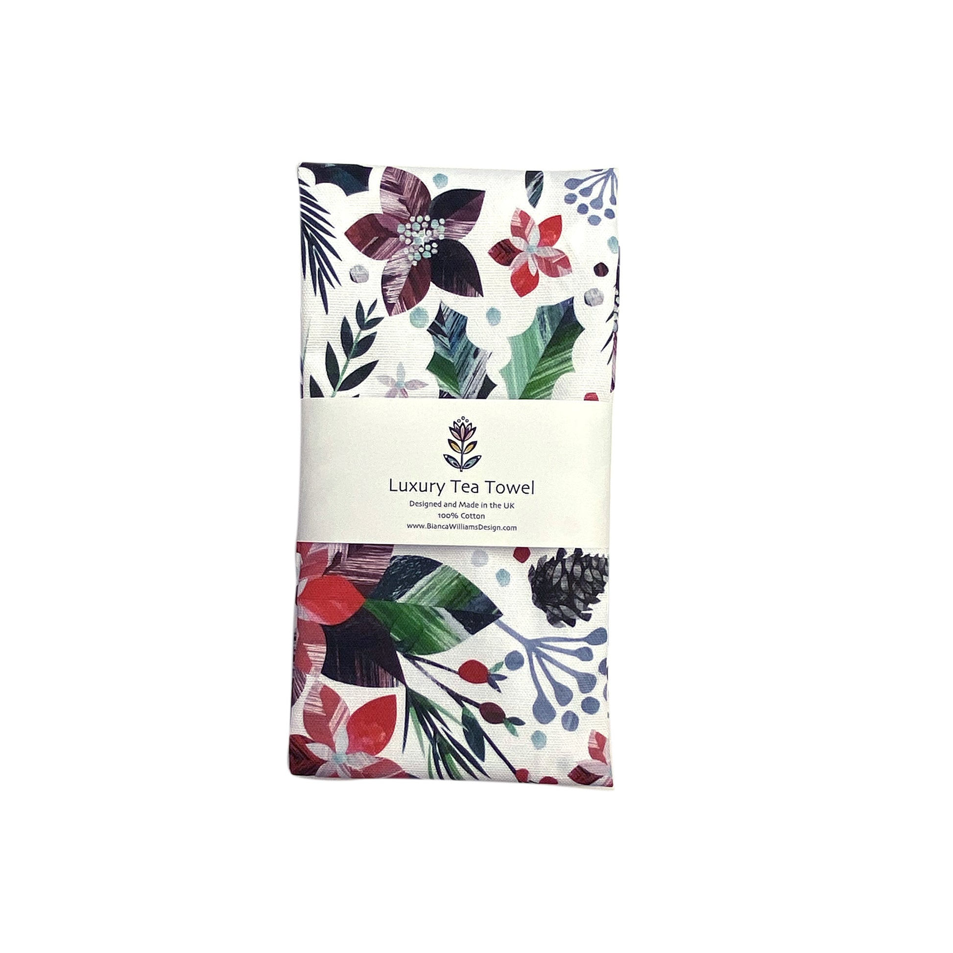 A winter floral tea towel has been packaged in a Brande belly band and placed on a white background.