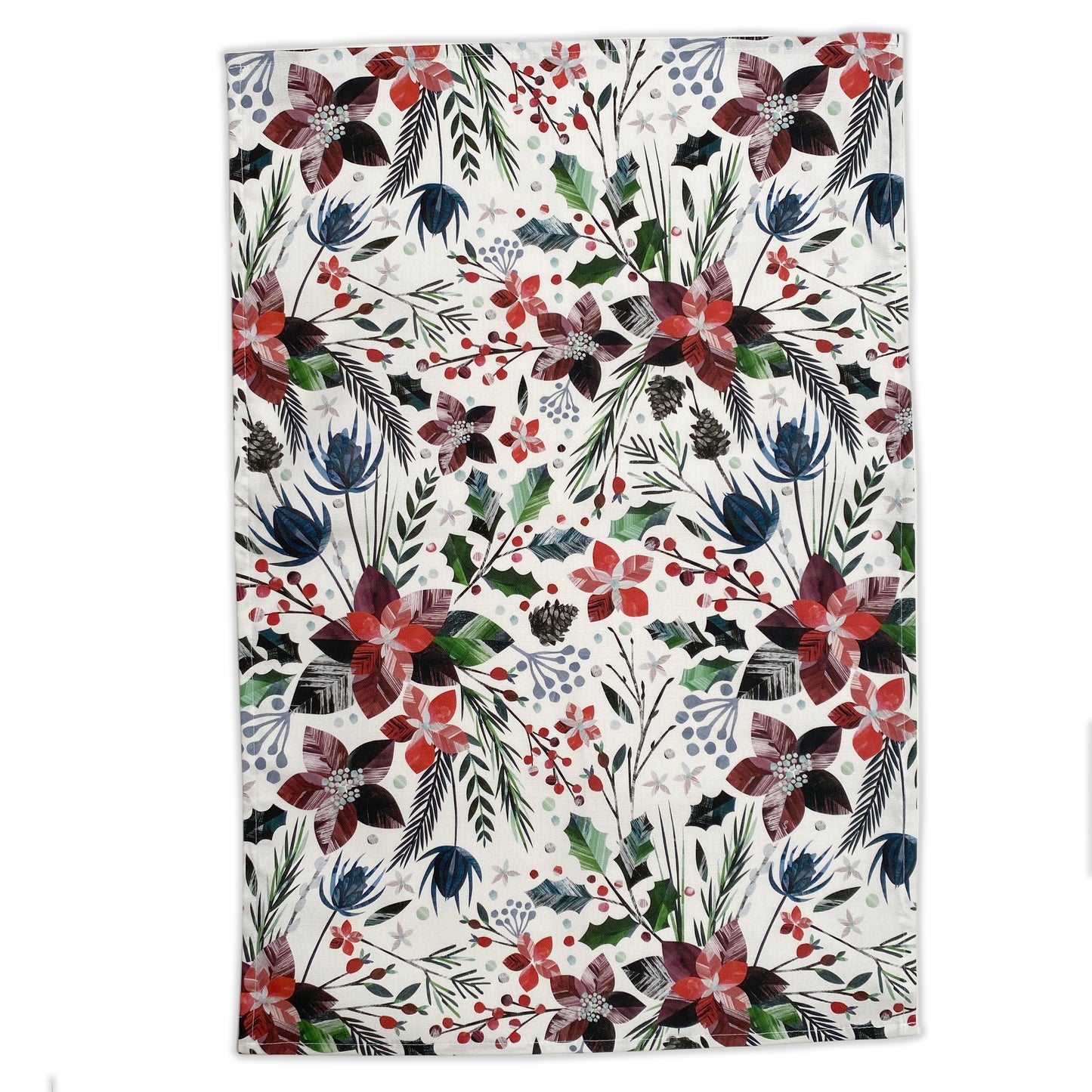 An opened out winter floral tea towel has been placed on a white background.  The tea towel features red poinsettia flowers and green holly, and fir and Brown Pinecones.