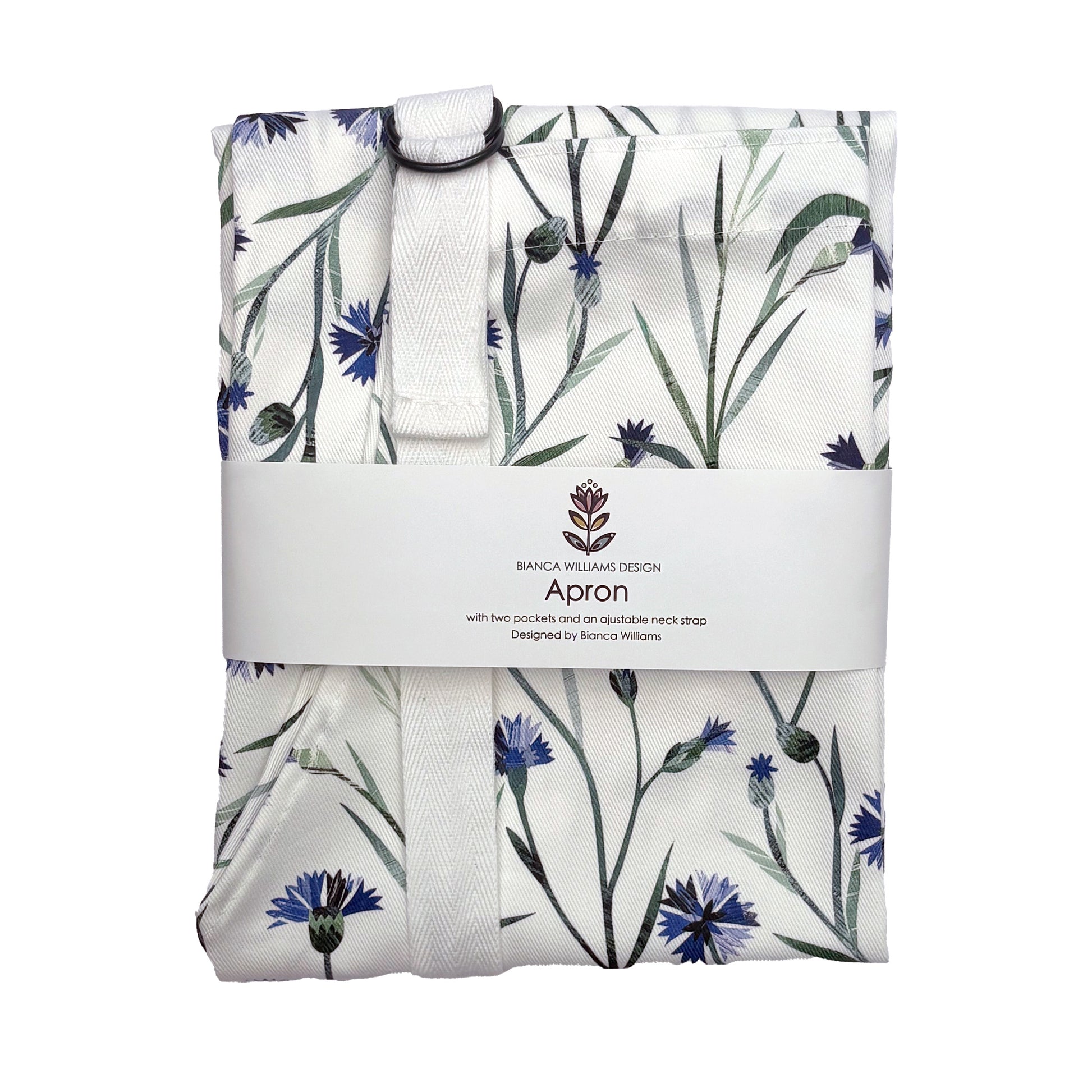 A packaged cornflower apron with white straps has been packaged in a Bianca Williams Design Packaging and placed on a plain white background.