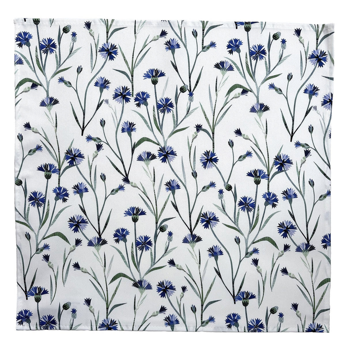 A cornflower napkin has been opened out and placed on a plain white background.  It features a delicate collaged floral pattern of the pretty blue Cornflowers with green leaves on a white background.