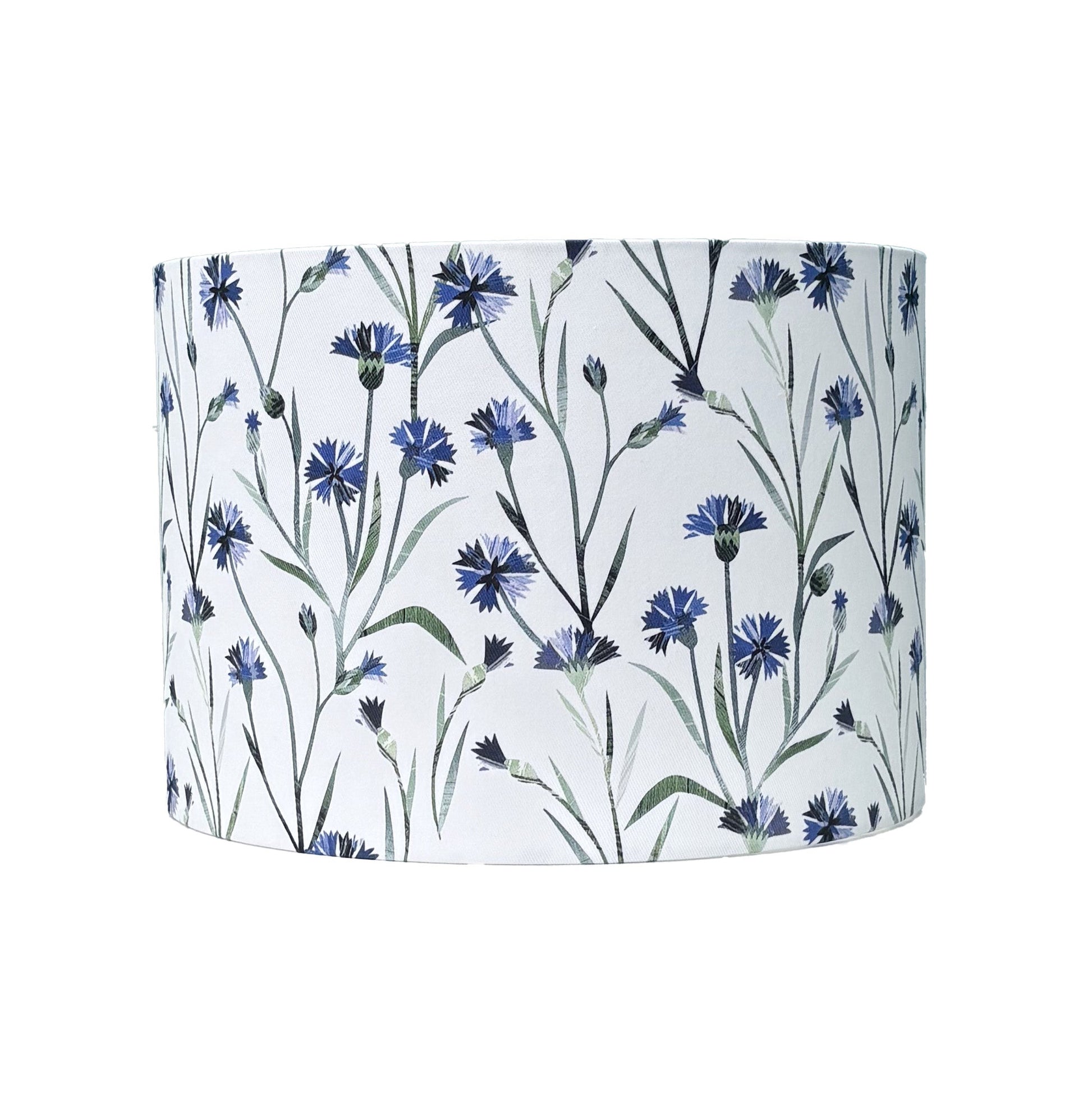 A Floral patterned lampshade featuring Blue Cornflowers with green leaves on a white background.