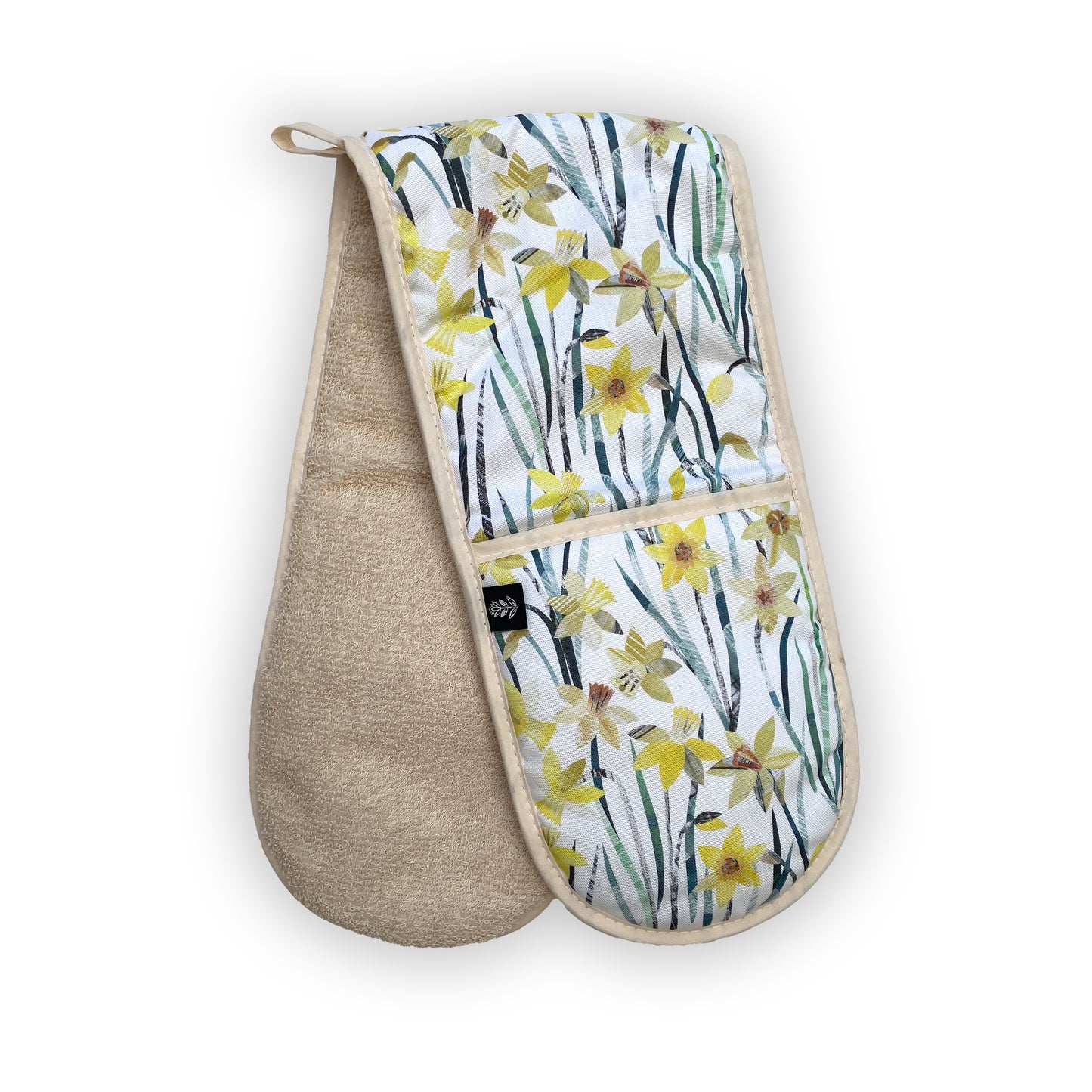 Daffodil Oven Gloves featuring a yellow and green textured daffodil pattern on a white background.  The have been placed at an angle so that the Ecru towelling backing can be seen.