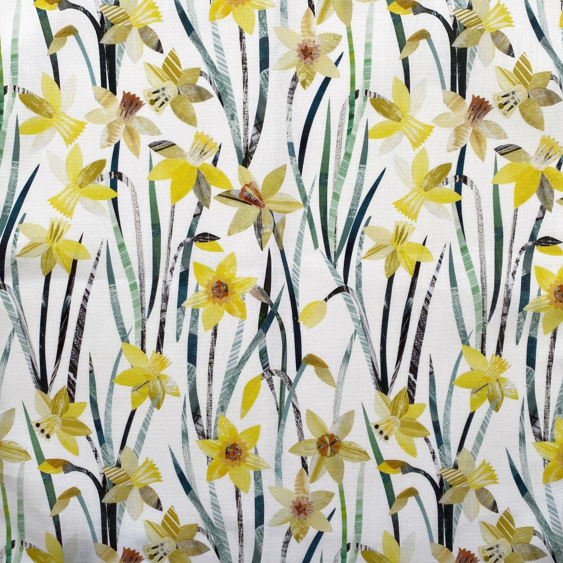 Daffodil fabric featuring textured yellow Daffodil flowers with green leaves on a white background.