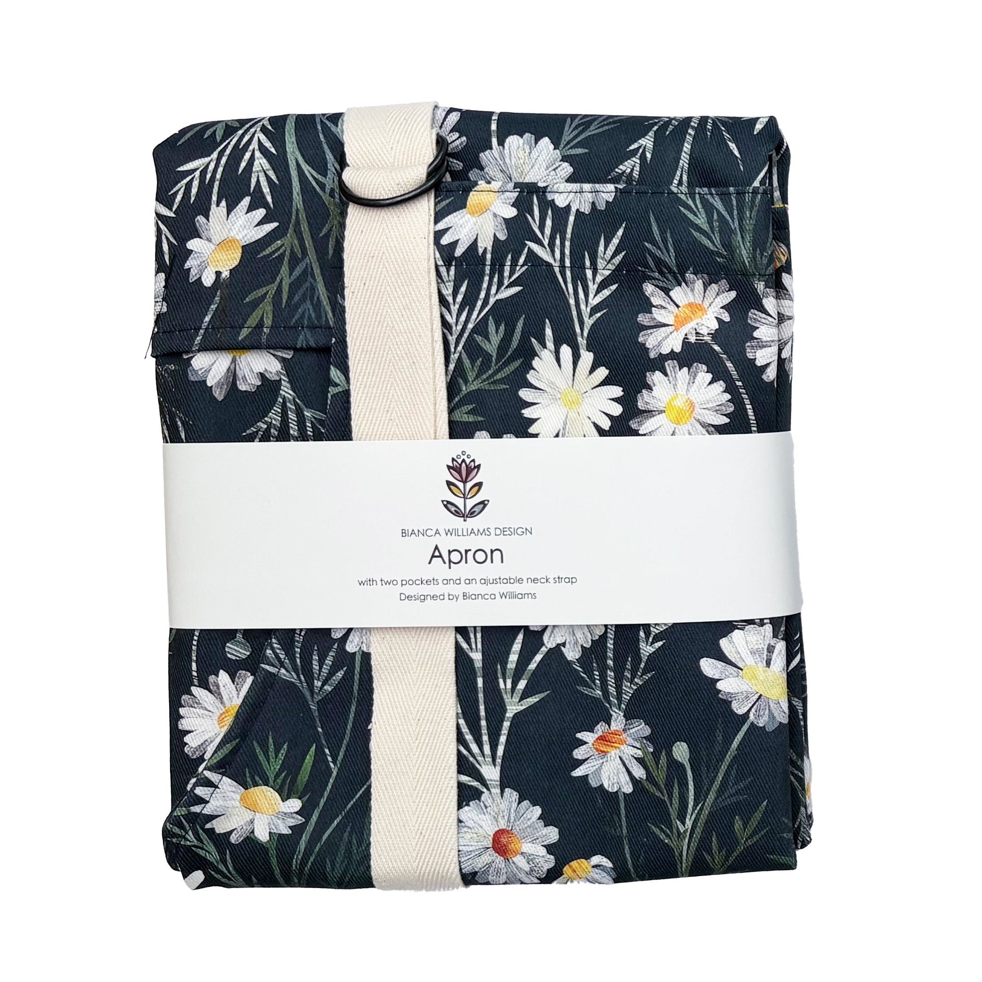 A packaged Daisy apron with Ecru straps has been packaged in a Bianca Williams Design Packaging and placed on a plain white background.