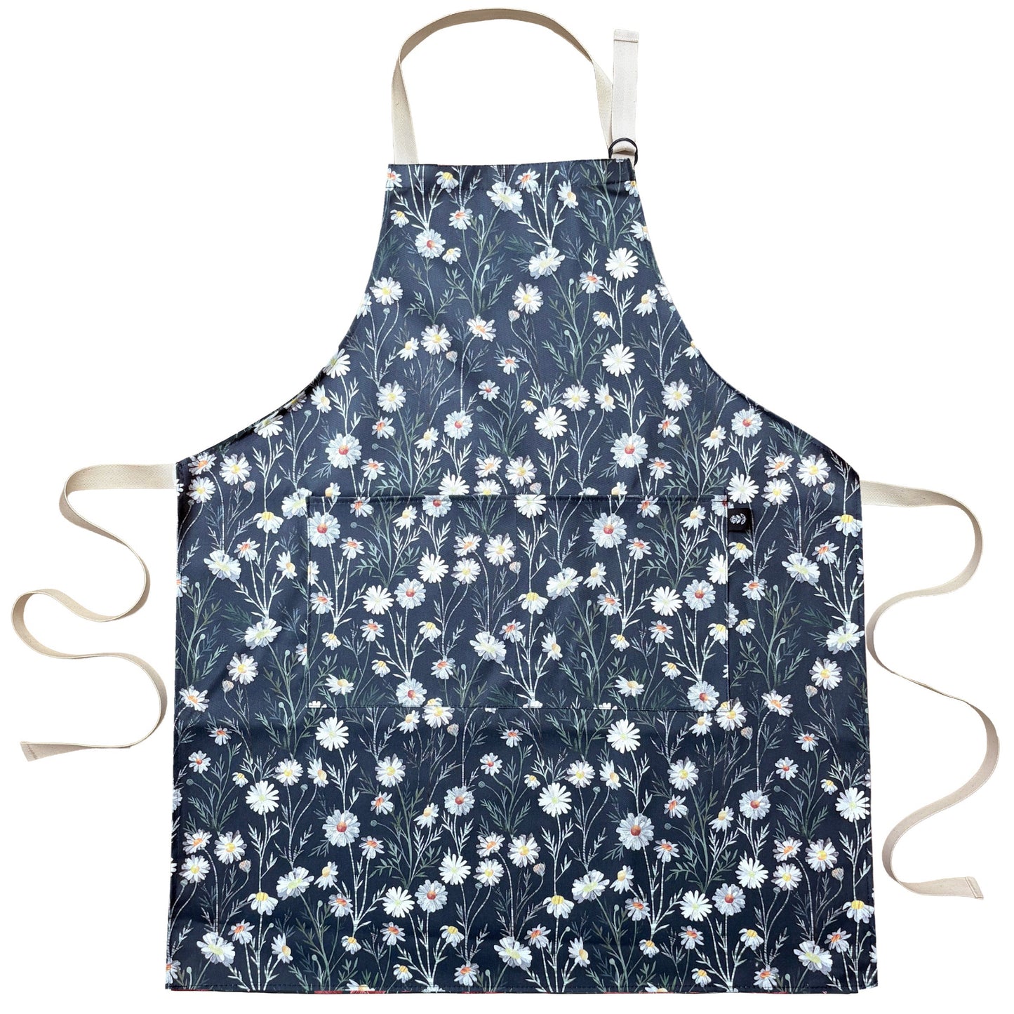 Floral apron with white Daisy flowers on a blue background.  The apron has been laid flat on a plain white background.