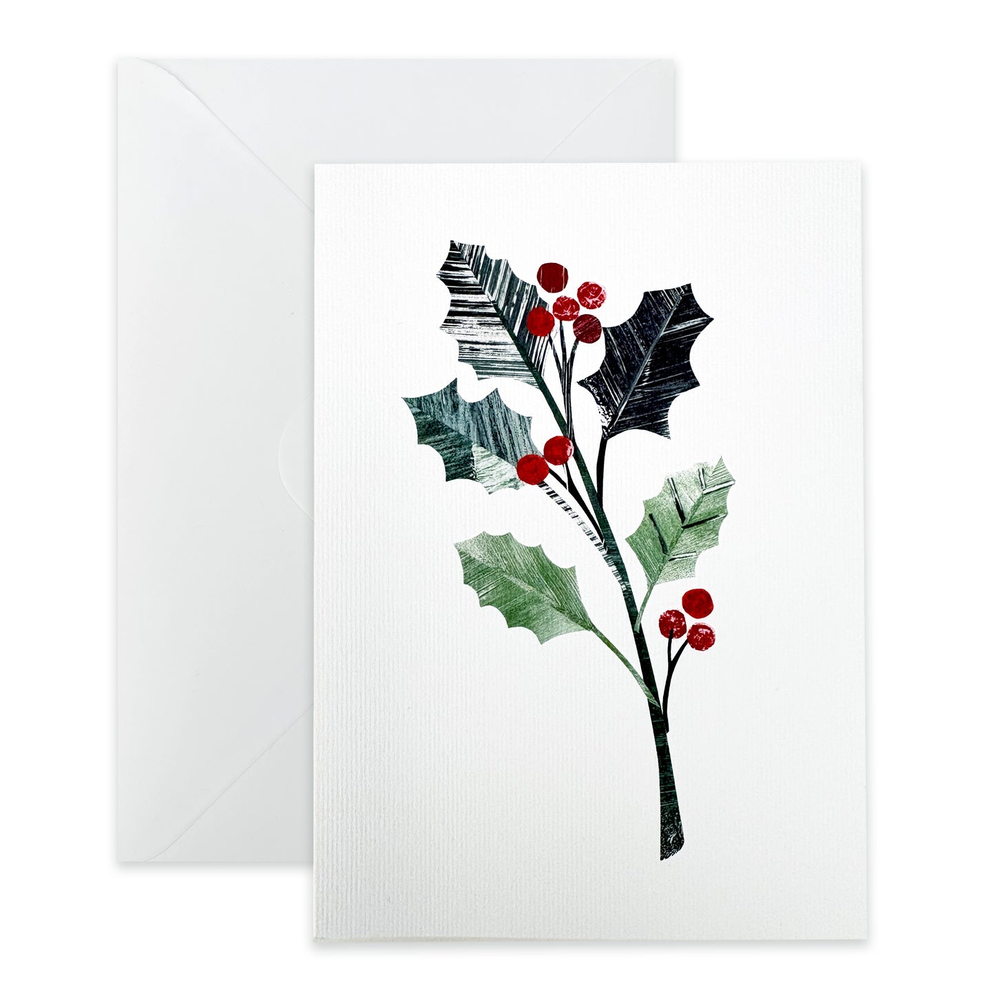 Greeting card with holly design and a plain white envelope on a white background.
