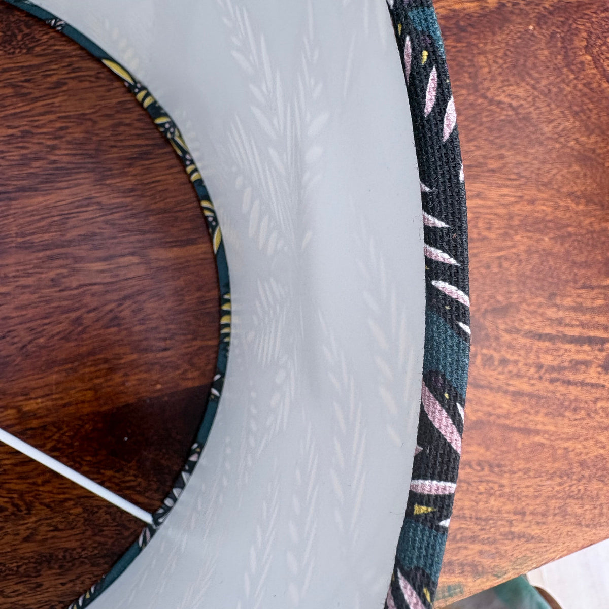 A close up of the inside of the lampshade, showing a small dent.