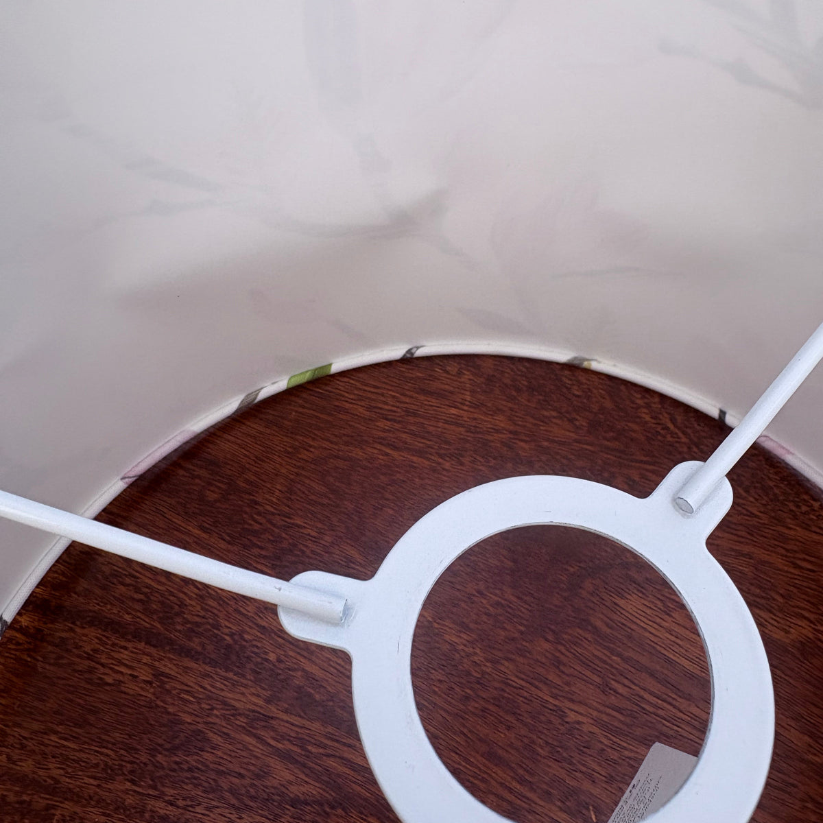 Inside of a magnolia lampshade that has been placed on a wooden table.