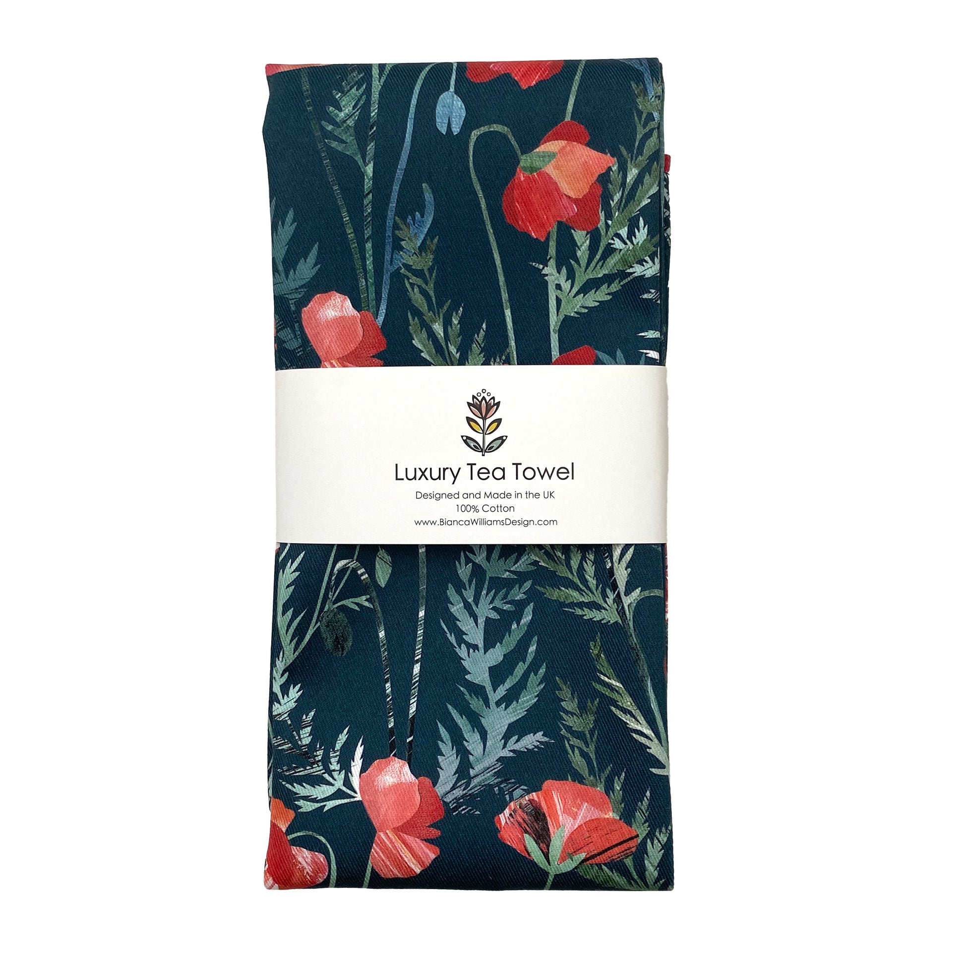 A Poppy Tea Towel featuring pretty Red Poppy Flowers with green leaves on a Dark Green background has been folder up and wrapped in a belly band and has been placed on a white background.