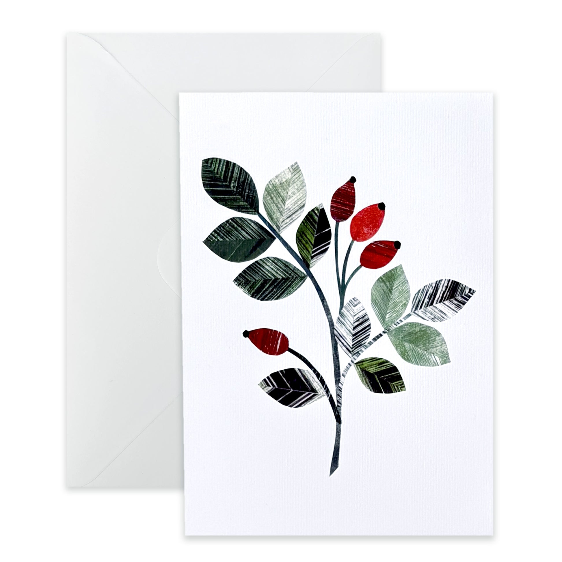 A white card with a Rosehip leaf sprig on it, featuring the bright red rose hip berries and textured green leaves.  It has been placed on a white background with a white envelope behind it.