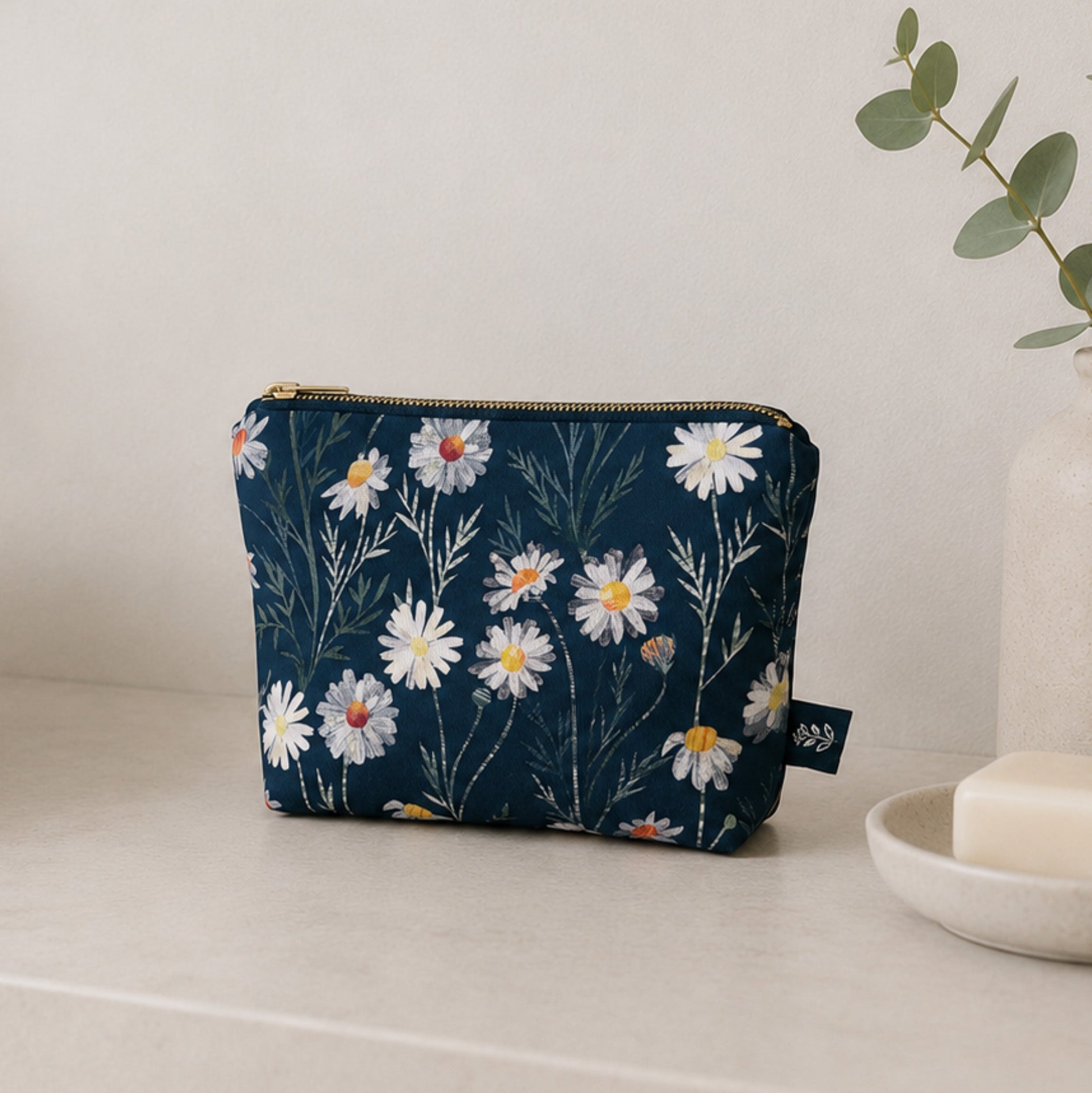 Daisy Floral-patterned pouch on a light surface with a neutral background