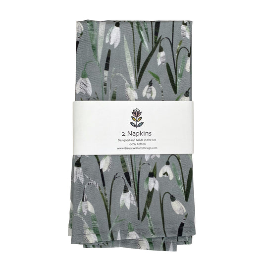 A pair of Snowdrops Napkins packaged in a branded belly band.