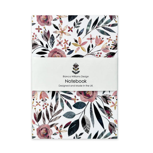 A Summer Floral Notebook has been packaged in a branded belly band and has been placed on a plain white background.