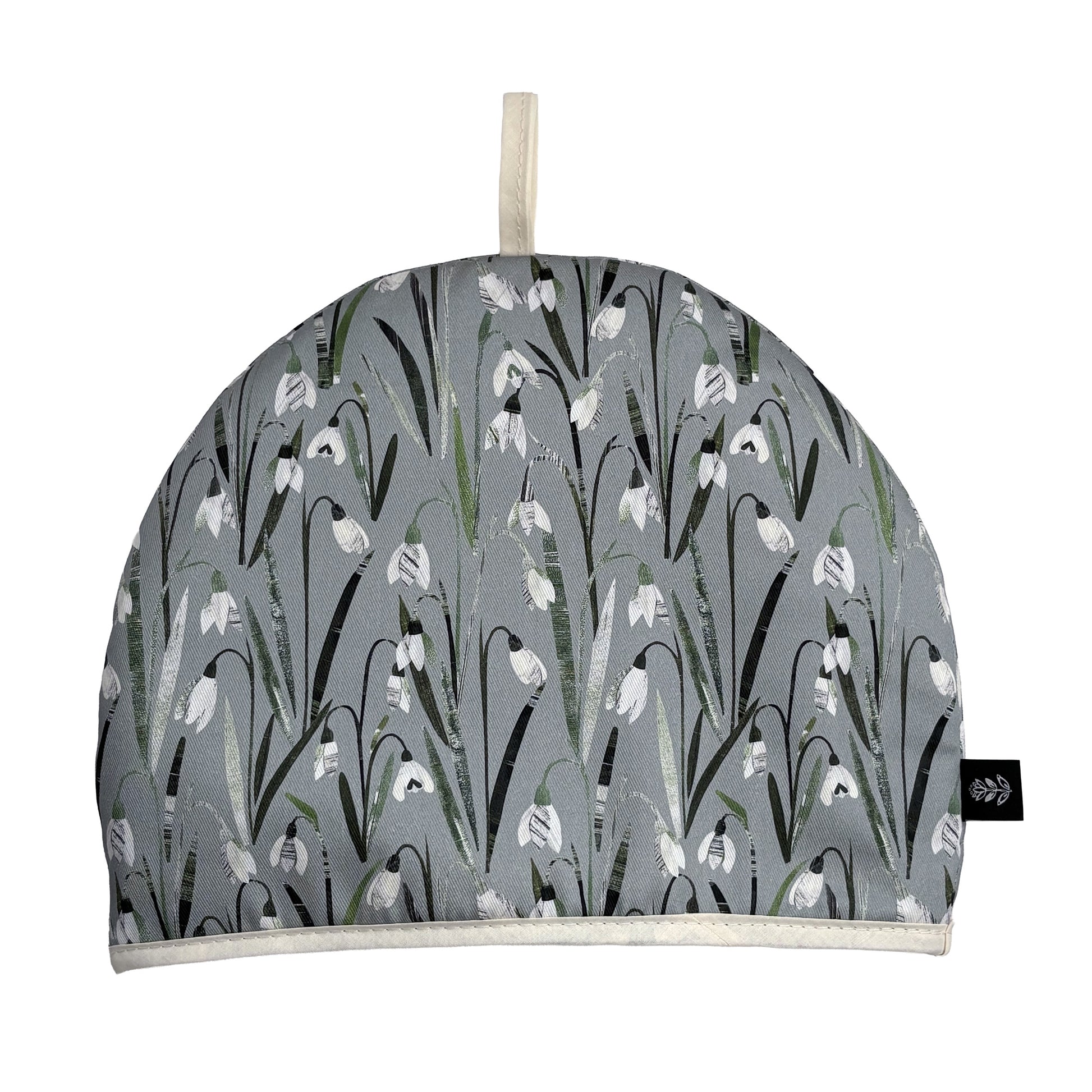 Snowdrop Tea cozy with white floral pattern on a white background.