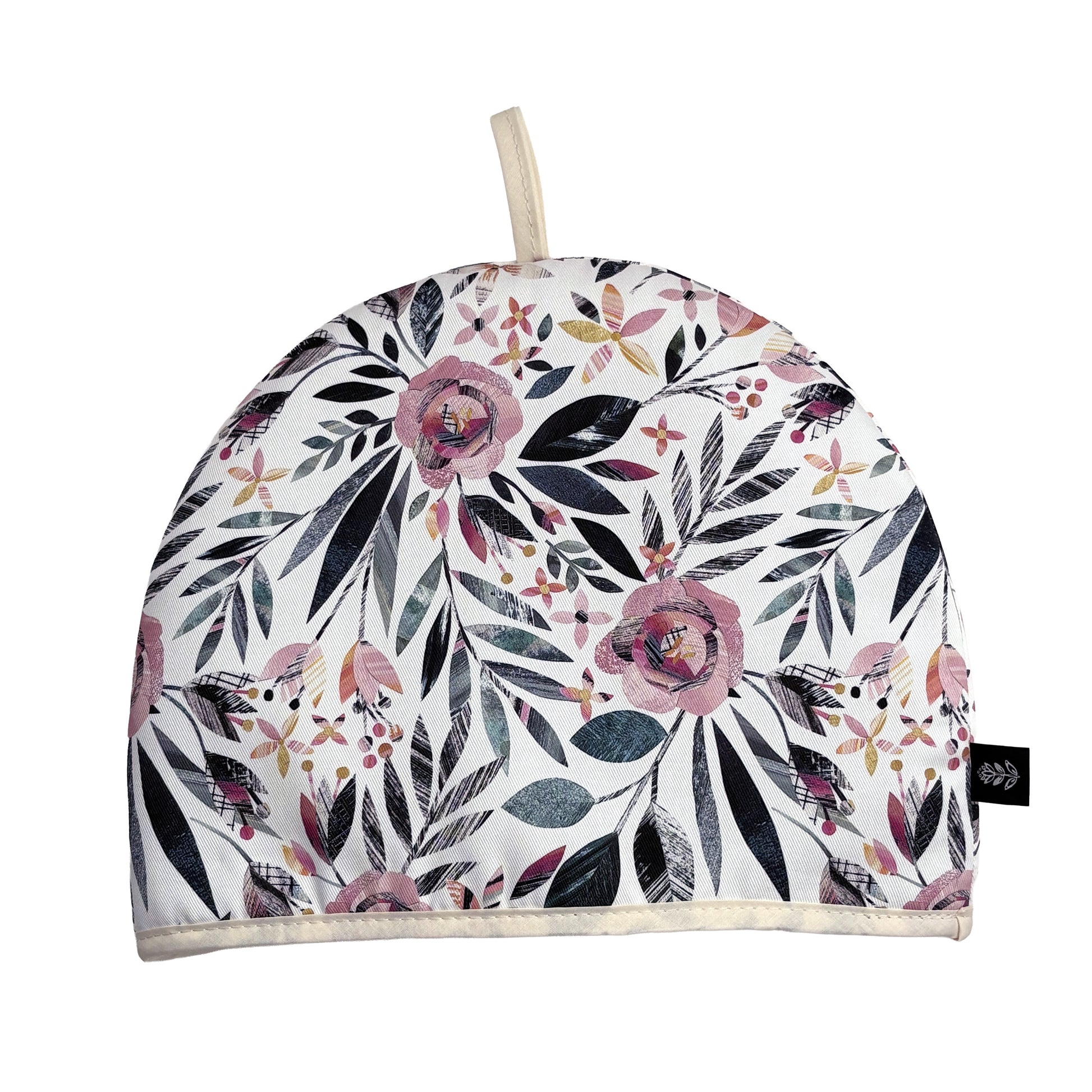 Summer Floral Tea cosy with pink roses and green leaves has been placed on a white background. A Brand label can be seen sewn into the seam and a cotton hanging tag out of the top.