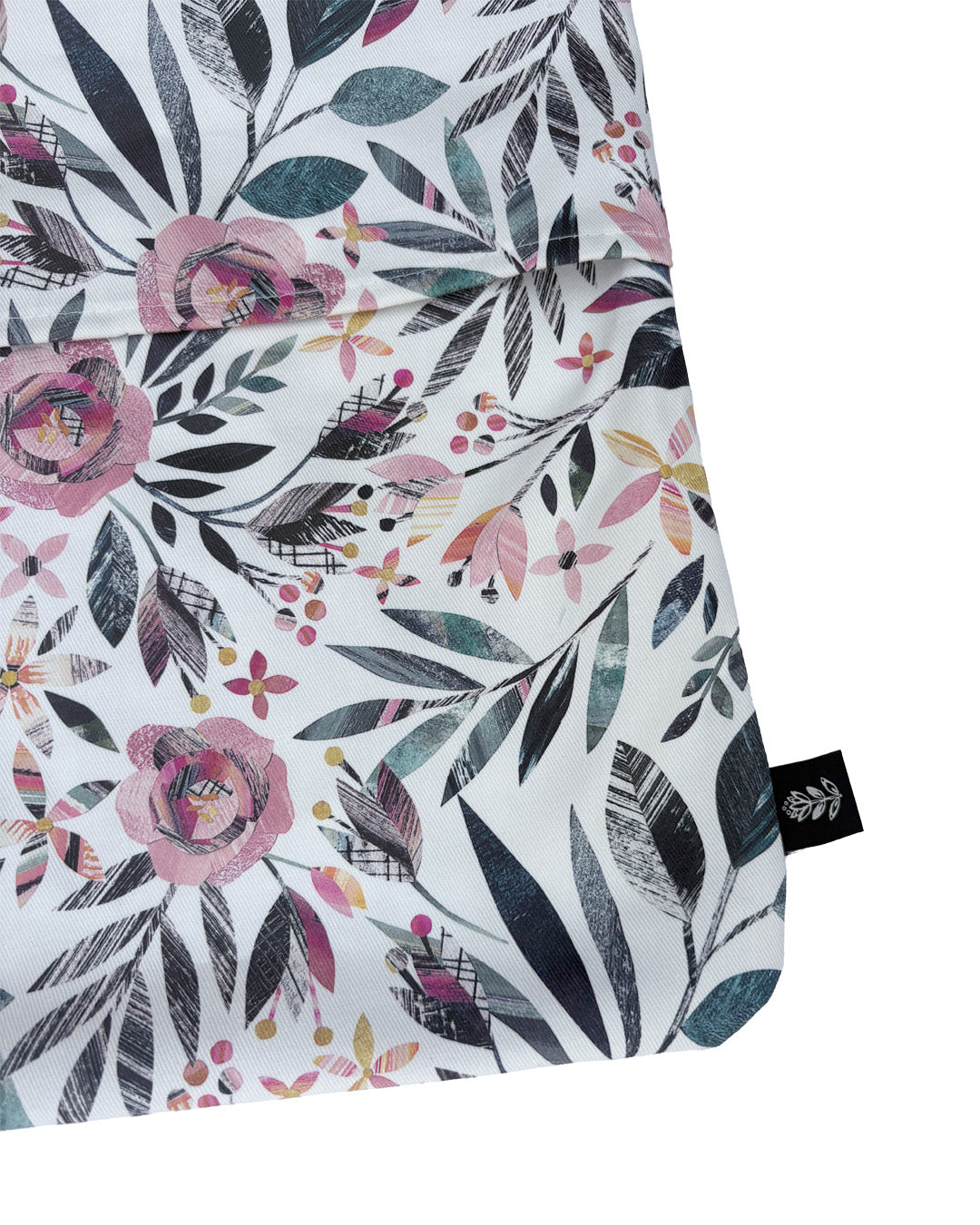 A close up of the Summer floral Peg bag, you can see the slit to get the peg in and out of it and you can also see the orange labels sewn into the outside seam.  It has been placed onto a plain white background.
