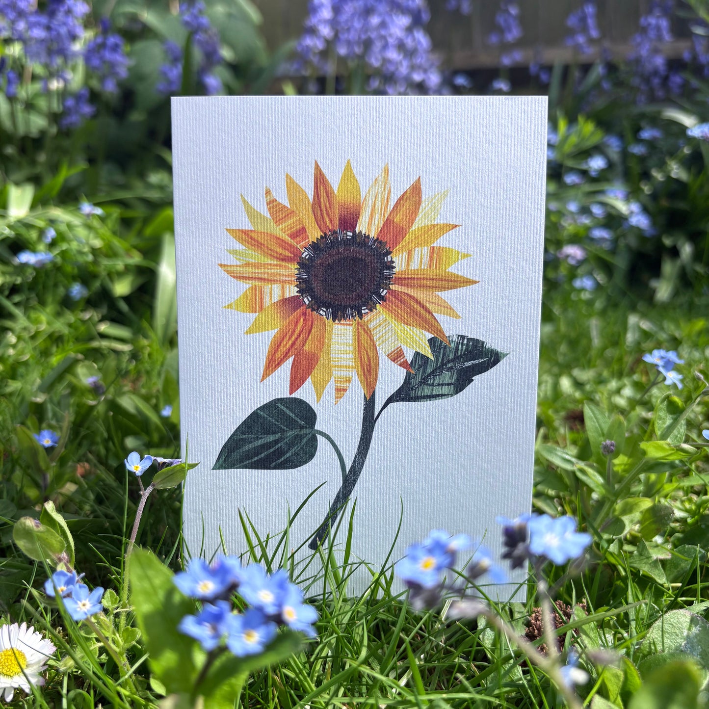 Card with a sunflower design in a garden setting