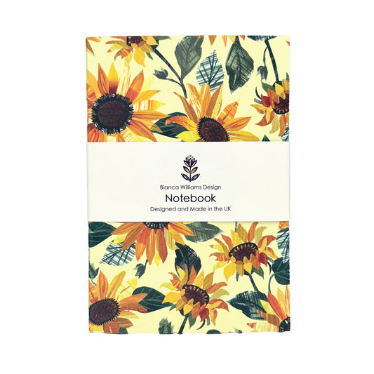 A Sunflower notebook packed in a branded white belly band has been placed on a white background.