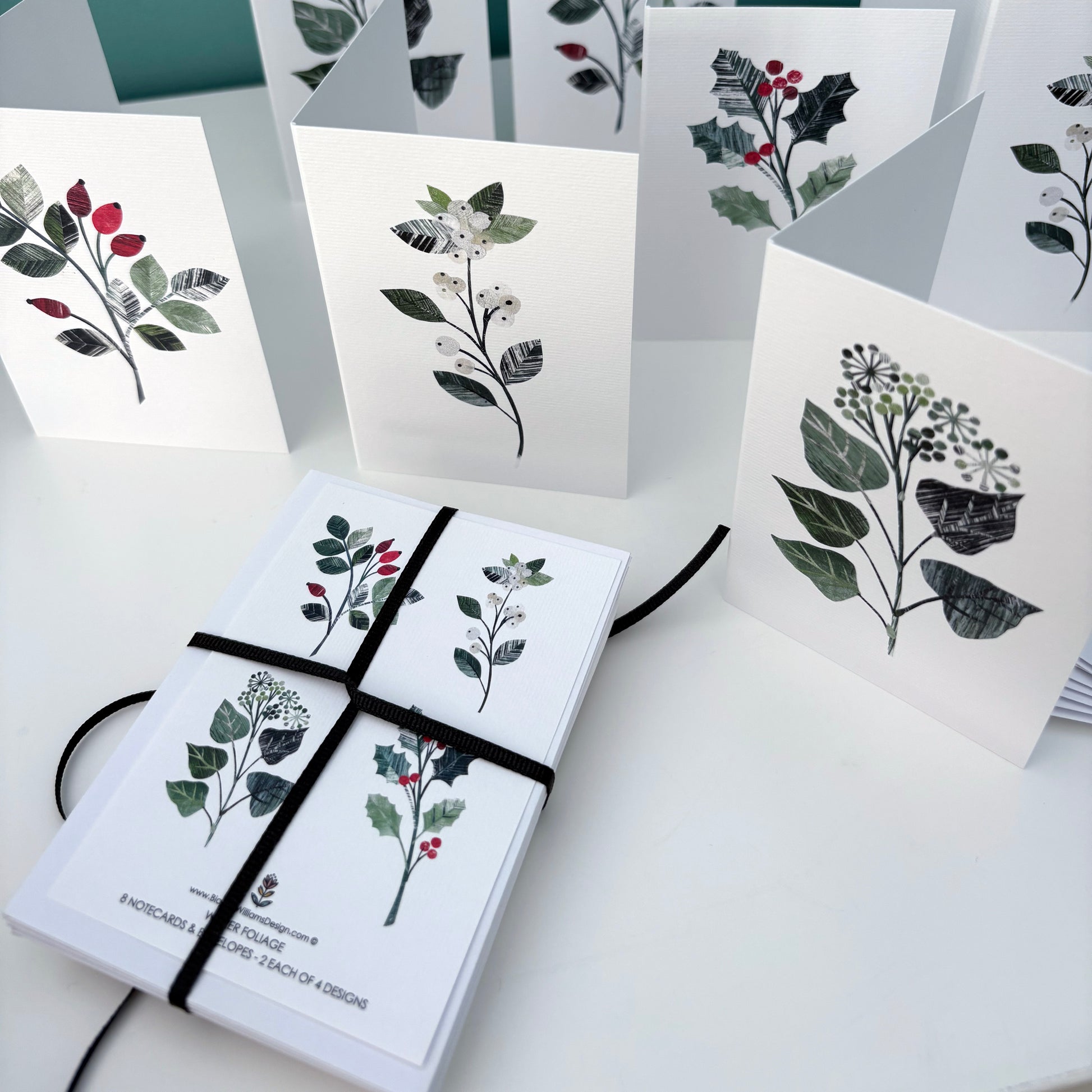 Set of Winter Floral greeting cards with floral designs on a white surface.