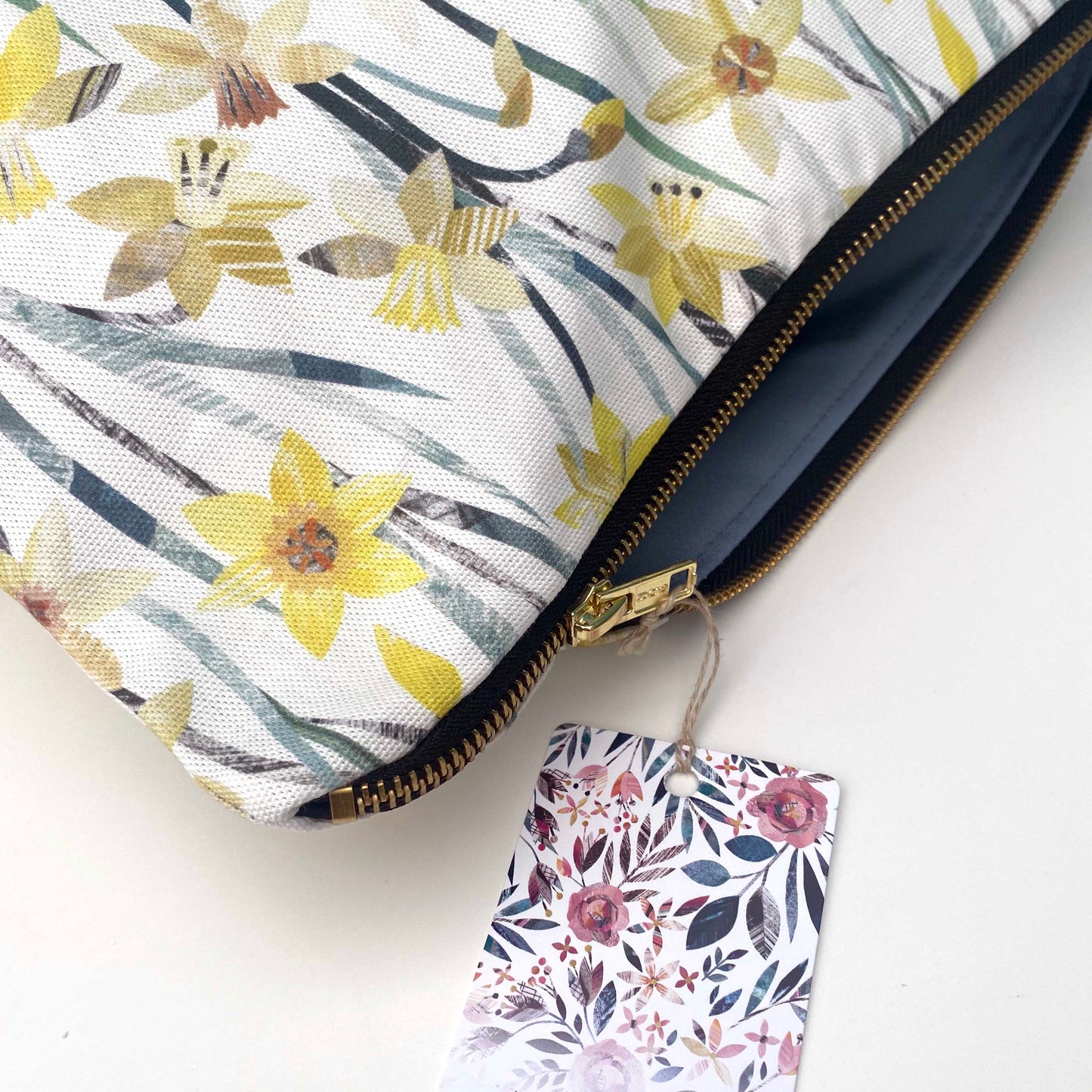 Close up of the Daffodil wash bag, you can see all the textures and tones of the daffodil print.  The bag has a gold metal zip and a colour coordinating green lining.