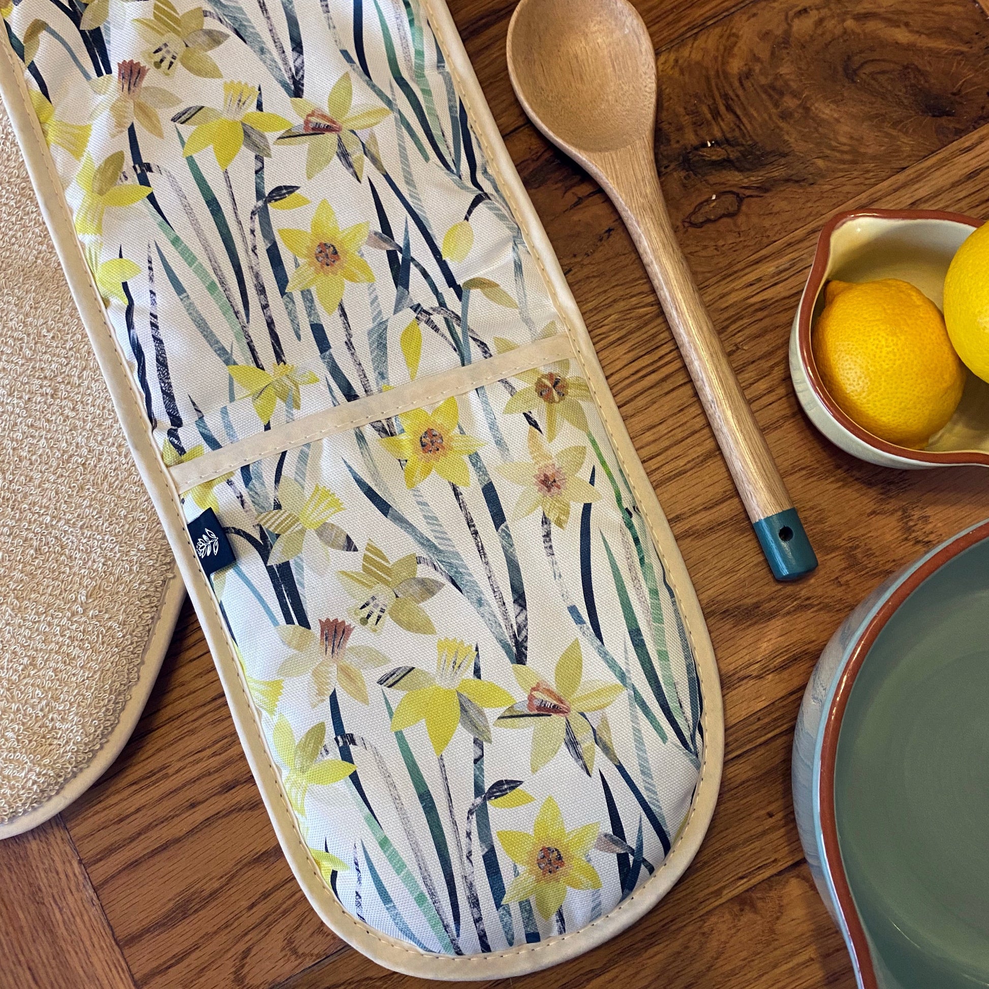 Daffodil Oven Gloves featuring one of Bianca's unique collaged designs.  These Oven Gloves have a thick thermal layer and they have a Ecru cotton towelling backing for added protection.