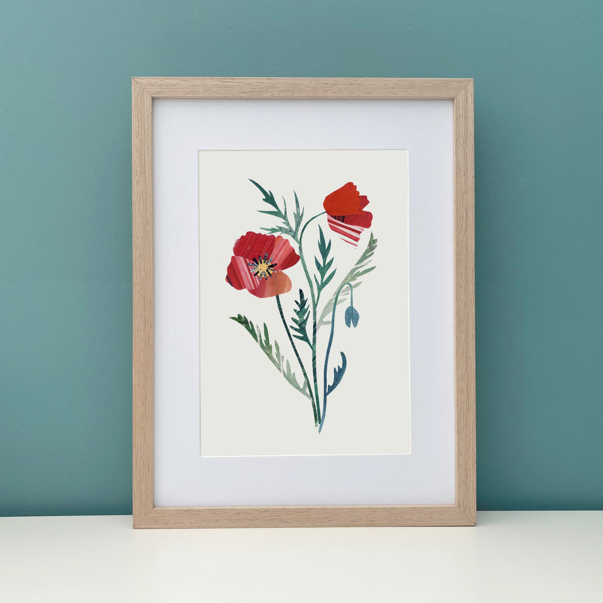 Framed artwork of a Red Poppy Flower on a teal wall.