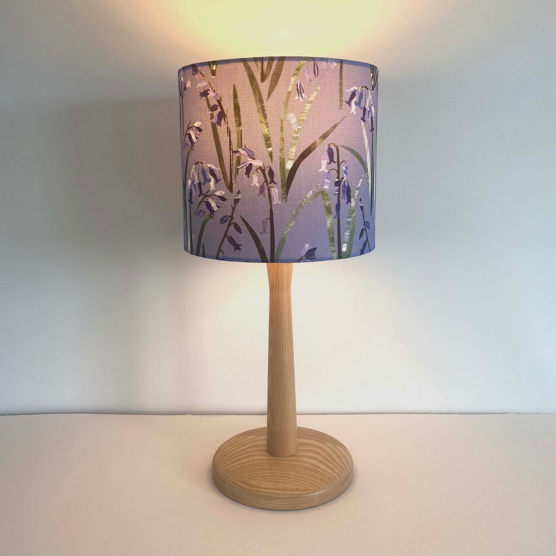 Small bluebell lampshade with the light on.